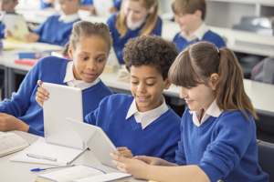 Pupils using tablets in classroom