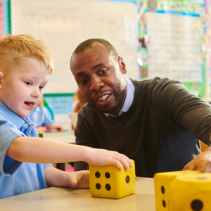 Male Teacher With Young Pupil