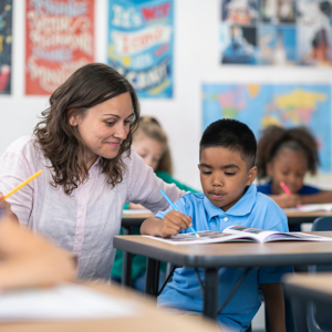 Female Teacher Supporting A Boy