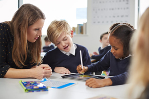 Female Primary Teacher With Two Pupils