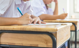 Image Of School Desk And Pupil Writing (1)